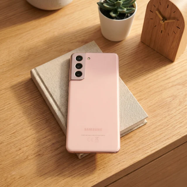 Lifestyle shot of Samsung Galaxy S21 5G Pink being held, showcasing its design