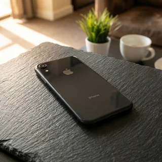 Refurbished iPhone XR in black being held, showing its size and screen in use