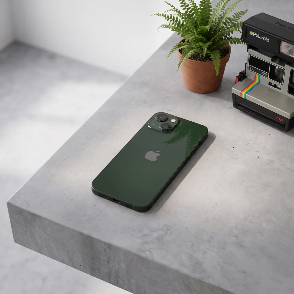 Apple iPhone 13 Green in hand, highlighting the smooth aluminium edges and excellent refurbished condition.