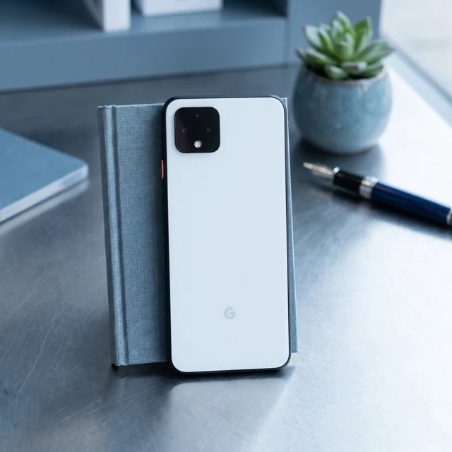 Person holding white Google Pixel 4 with screen on, demonstrating practical use of the refurbished phone