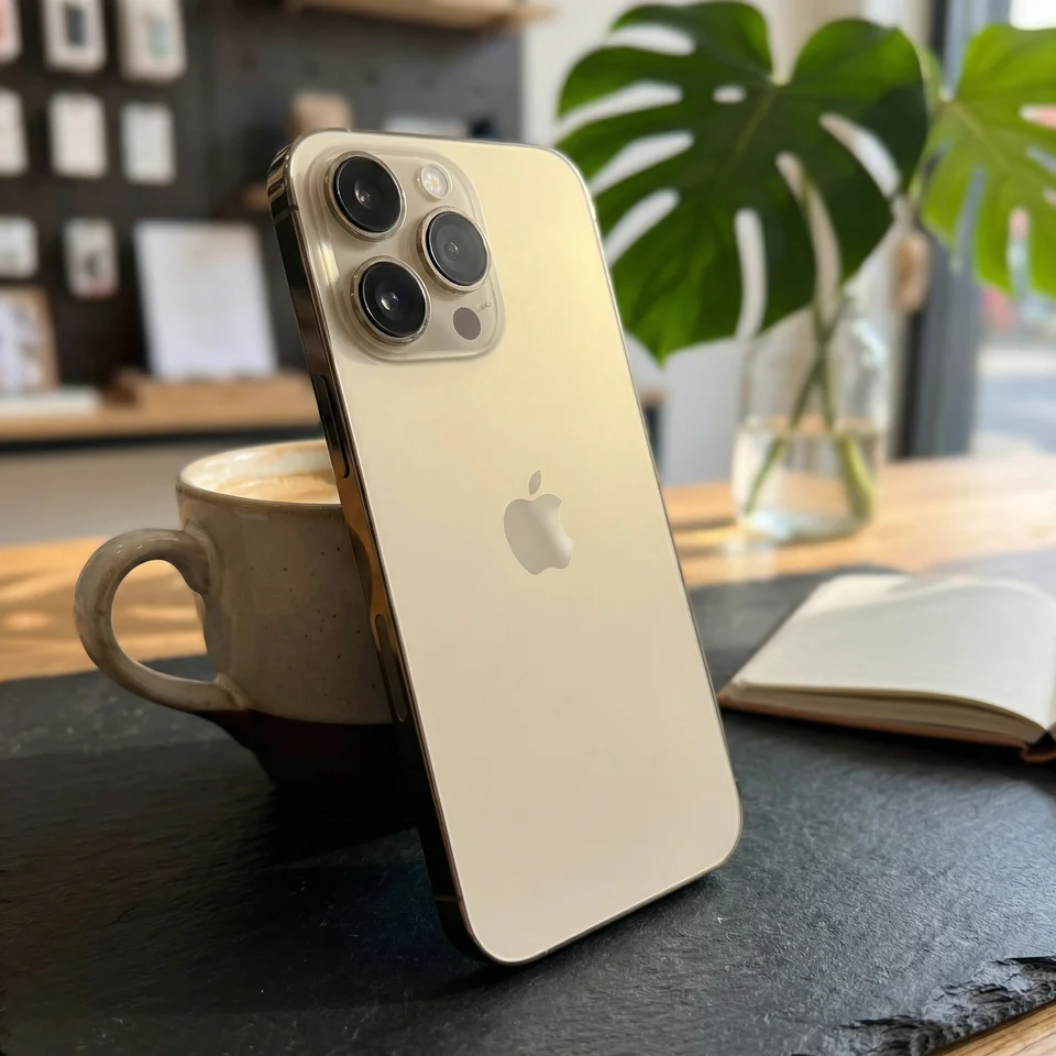 Lifestyle image of a refurbished Gold iPhone 14 Pro