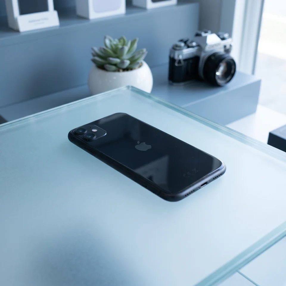 Lifestyle shot of the refurbished iPhone 11 64GB Black being held, showing premium design