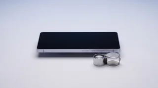 A refurbished iPhone, iPad and Apple Watch arranged neatly on a clean studio surface