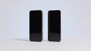 A single iPhone 15 Pro lying flat on a clean pale-grey studio surface with its screen dark, an unfinished arc of blue light curving around it on the background like a countdown