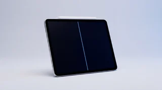 A single iPad Pro lying flat with an Apple Pencil drawing an unsteady wavy trail of blue light across its dark screen