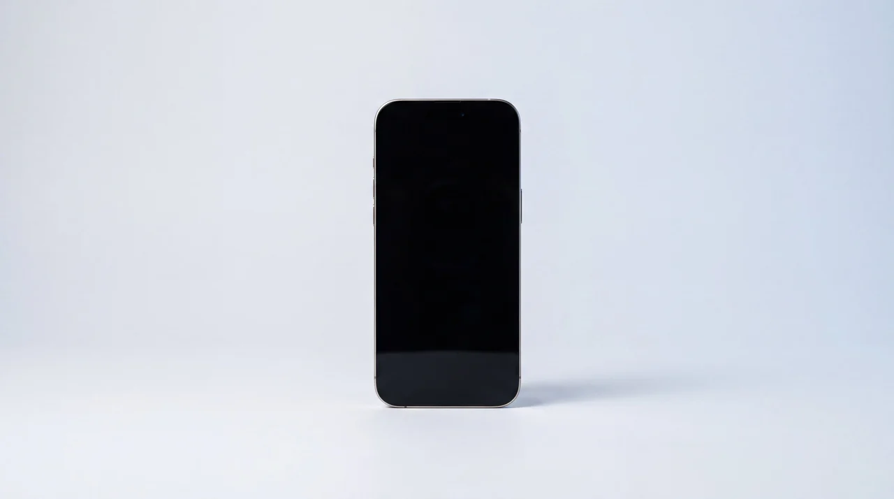 A single clean refurbished iPhone with plenty of empty space around it on a studio surface