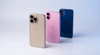 An older navy iPhone 12 and a newer titanium iPhone 16 Pro Max standing upright with a soft blue arc of light flowing between them, transferring data