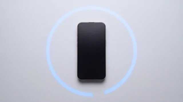 A single iPhone 15 Pro lying flat on a clean pale-grey studio surface with its screen dark, an unfinished arc of blue light curving around it on the background like a countdown